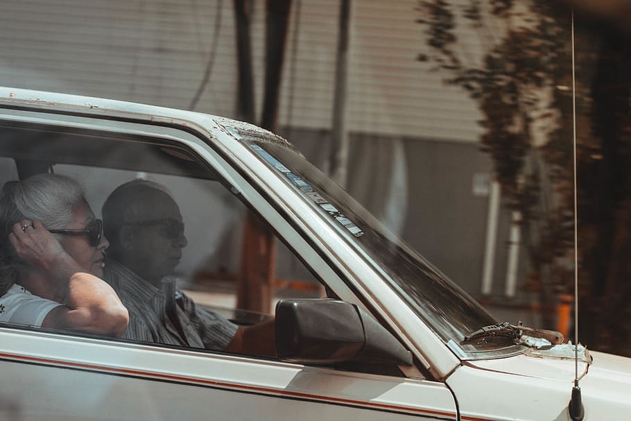 man and woman in vehicle, person, human, automobile, car, transportation