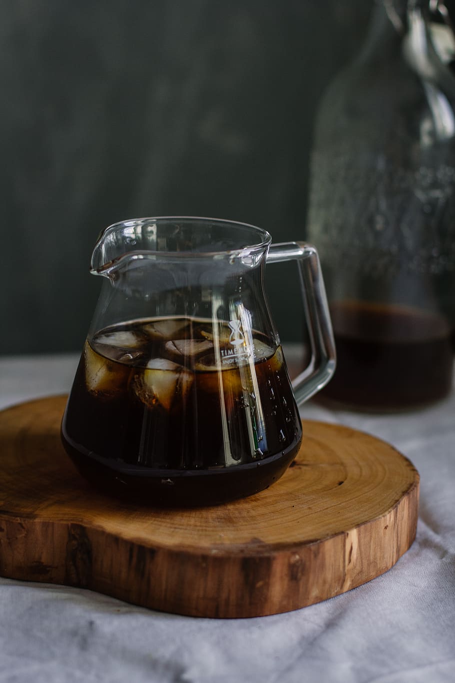 Clear Glass Pitcher With Cola and Ice on Wooden Chopping Board HD wallpaper
