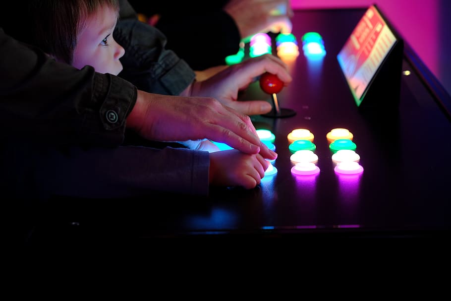 boy playing arcade cabinet, arts culture and entertainment, indoors