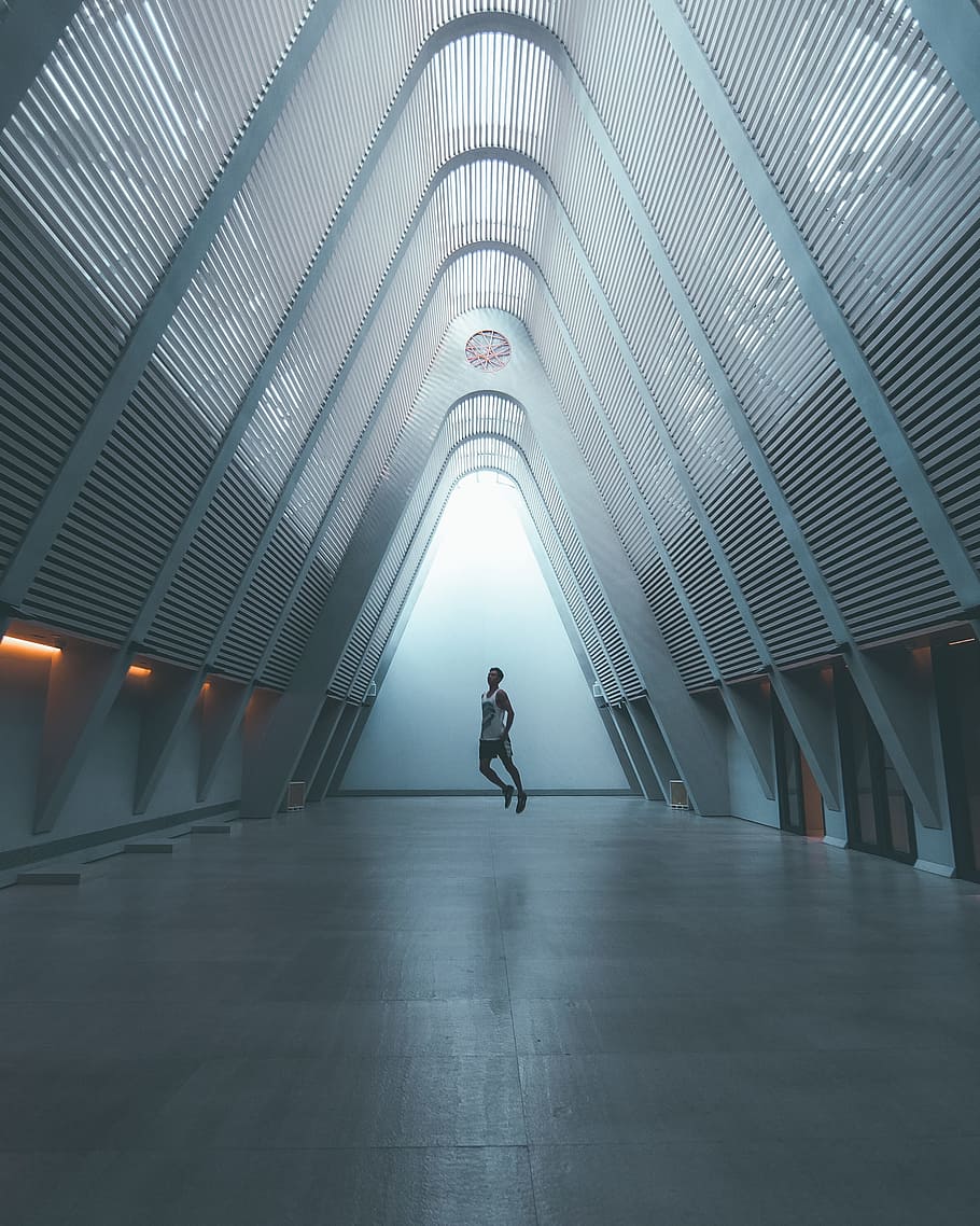 person standing inside gray metal structure, building, float