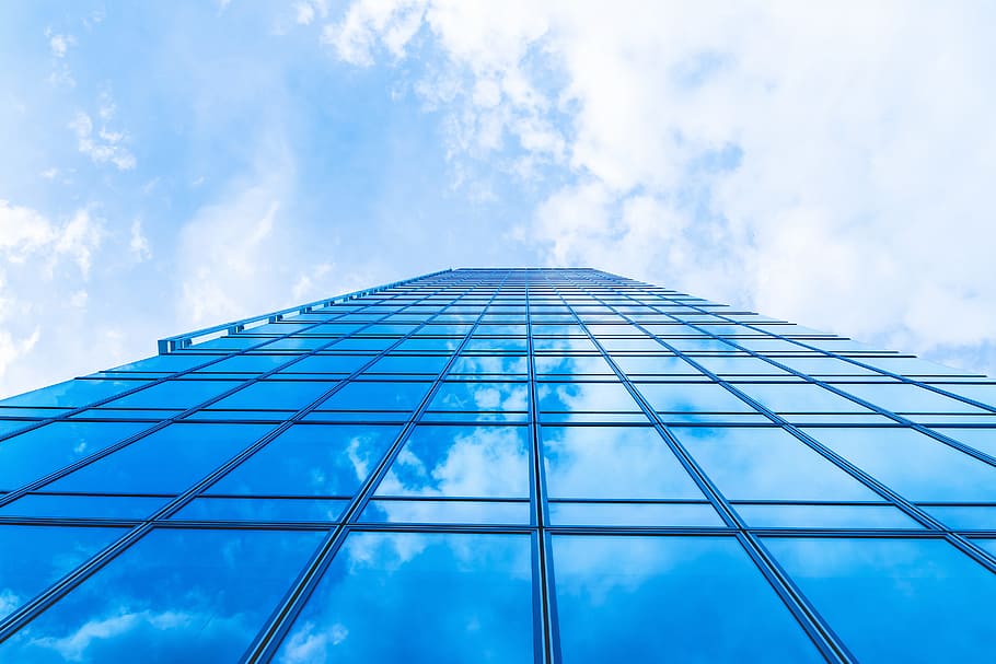 Sky with clouds in the reflection in windows of modern office building HD wallpaper