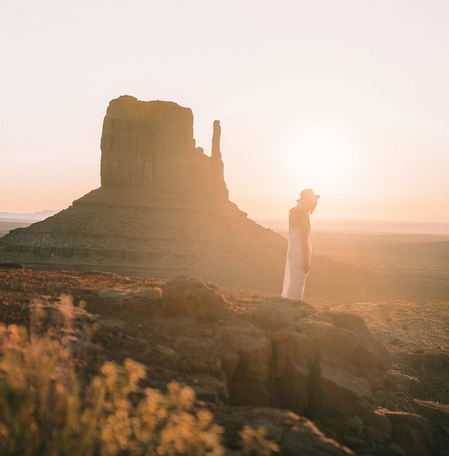 woman in white dress standing on rocky mountain, desert, sunset HD wallpaper