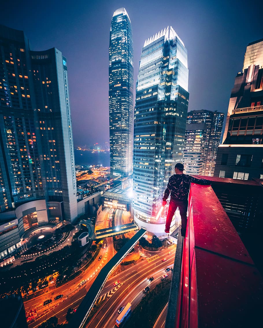 man parkour on a building, skyscraper, cyberpunk, daredevil, street