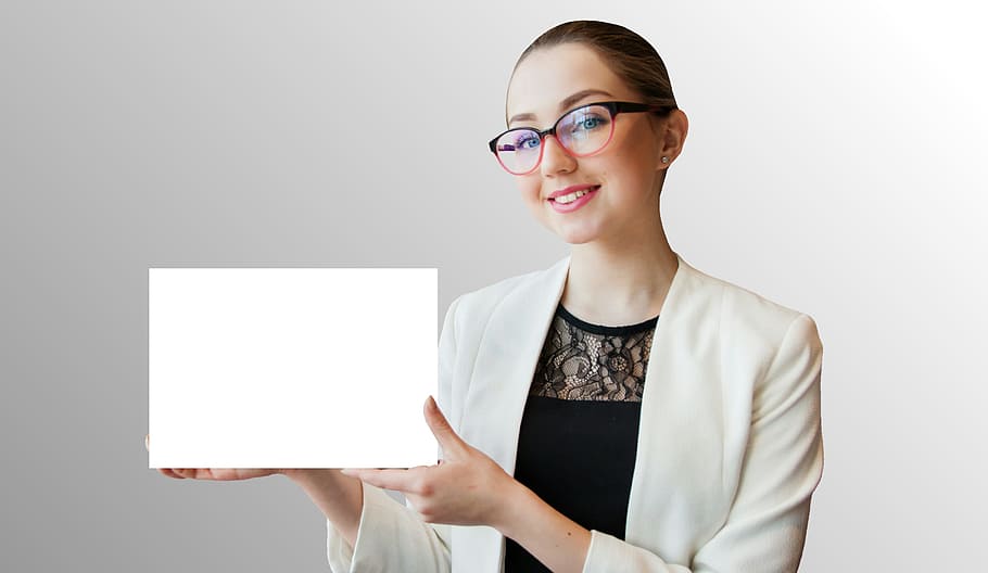 Photo of woman holding blank white sign in her hands, advertising