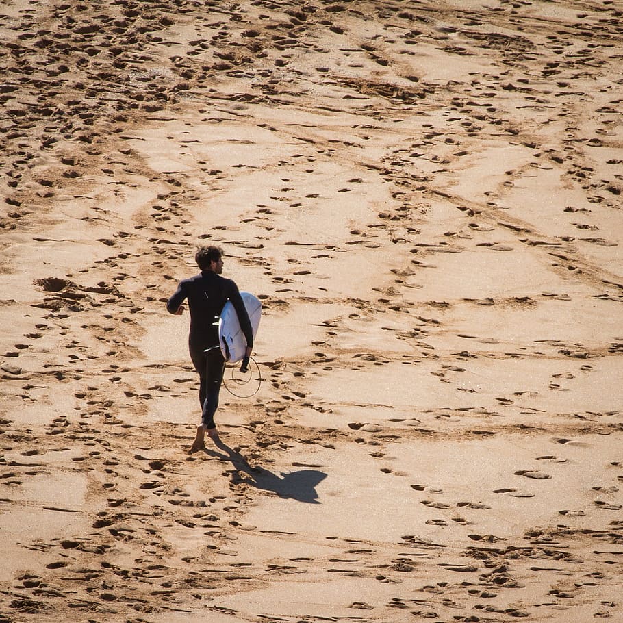 man carrying white surfboard standing on ground, beach, sand HD wallpaper