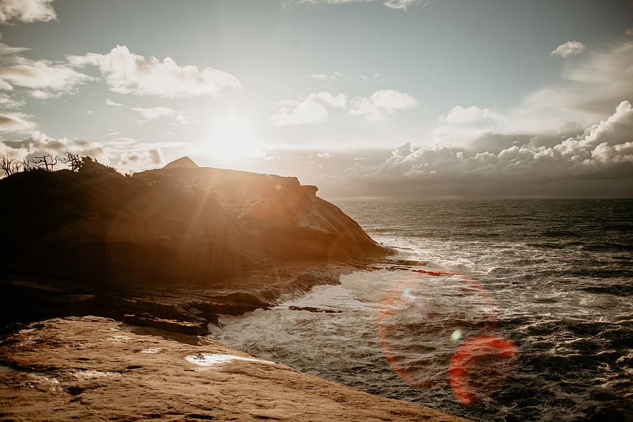 flare, light, ocean, promontory, nature, outdoors, sea, water HD wallpaper
