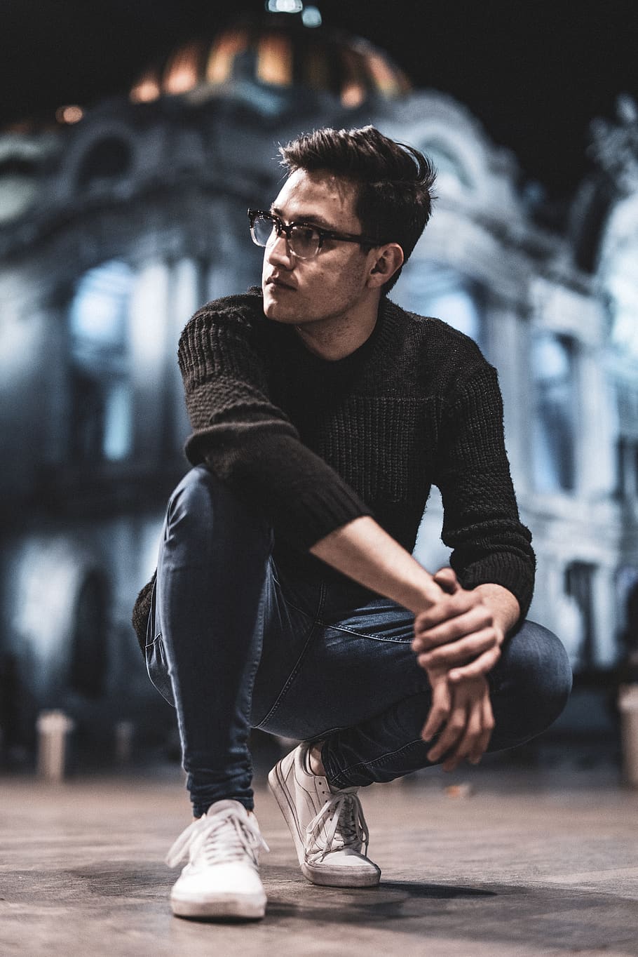 man sitting while wearing black sweater, clothing, apparel, footwear HD wallpaper