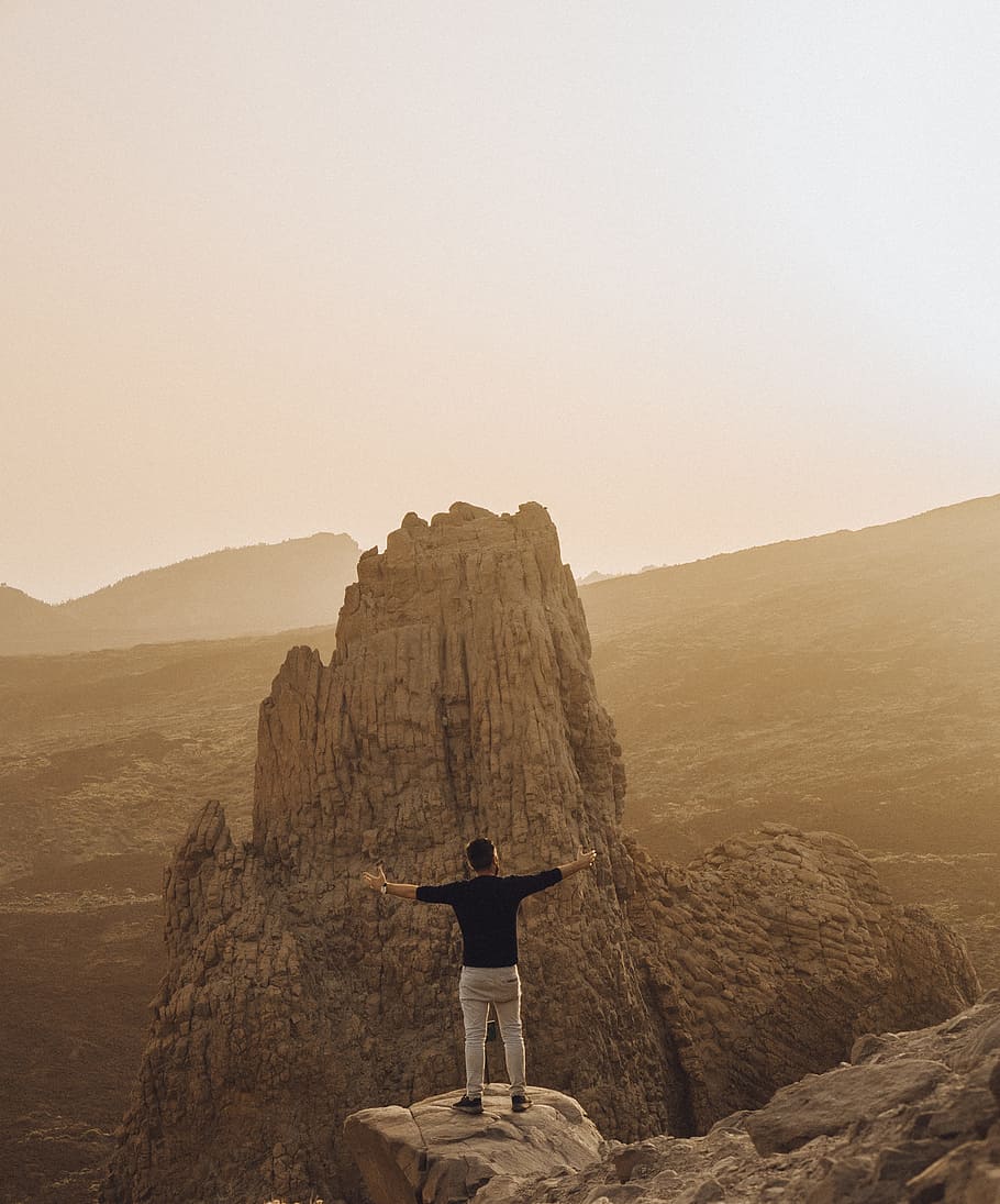 person standing beside cliff during daytime, hands, outdoors HD wallpaper
