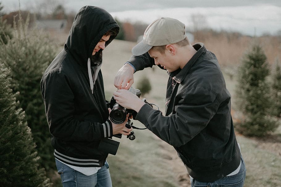 man fixing DSLR camera while man holding, movie, person, handy man HD wallpaper