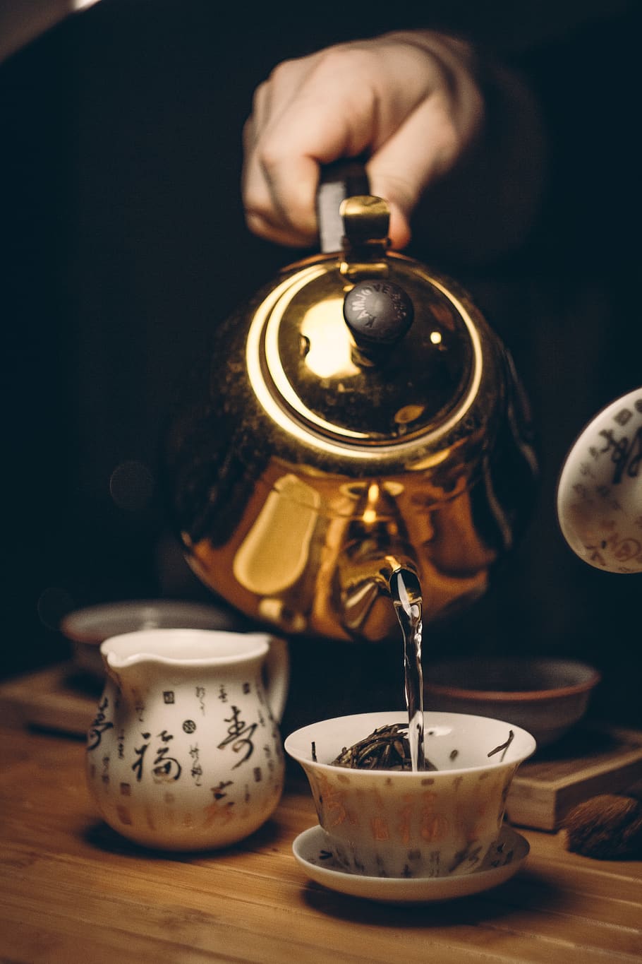 Person Holding Gold Teapot Pouring White Ceramic Teacup, beverage HD wallpaper