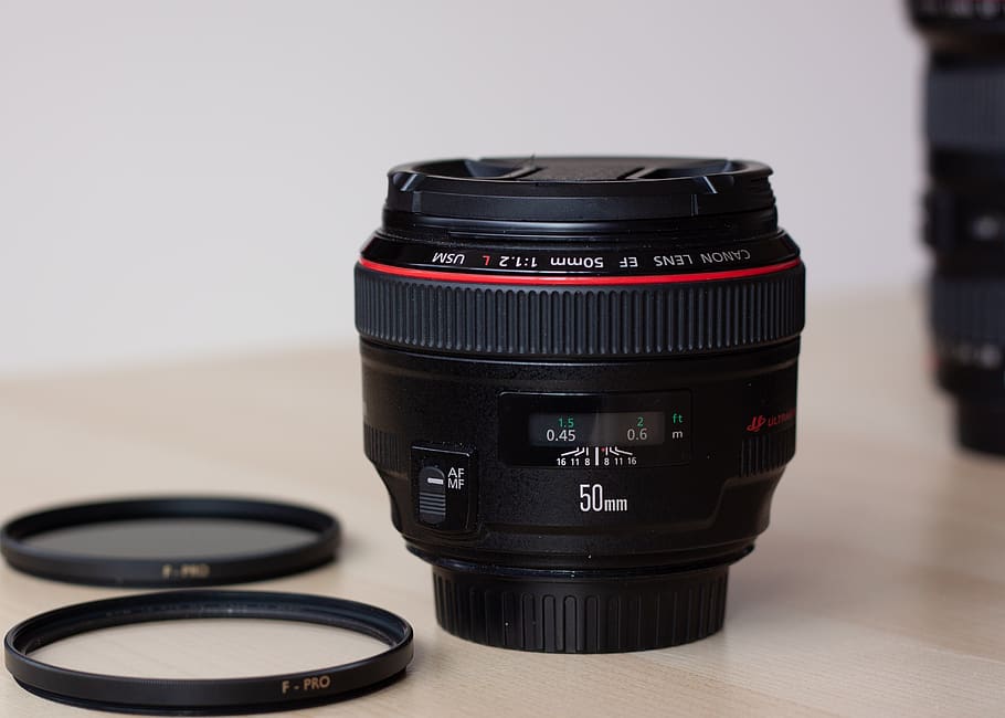 camera lens on brown table, electronics, lens cap, wristwatch HD wallpaper