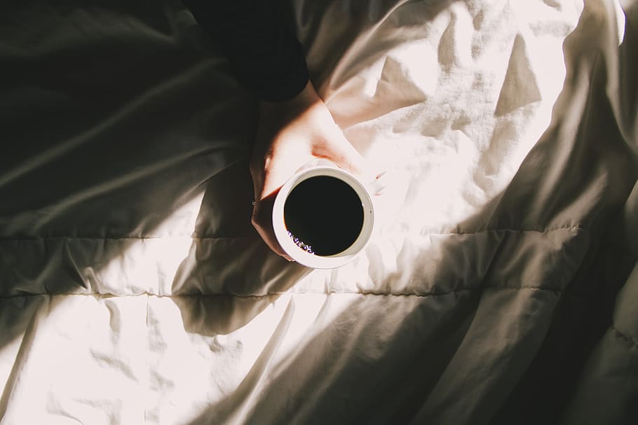 white ceramic mug, bed, one person, textile, furniture, real people HD wallpaper