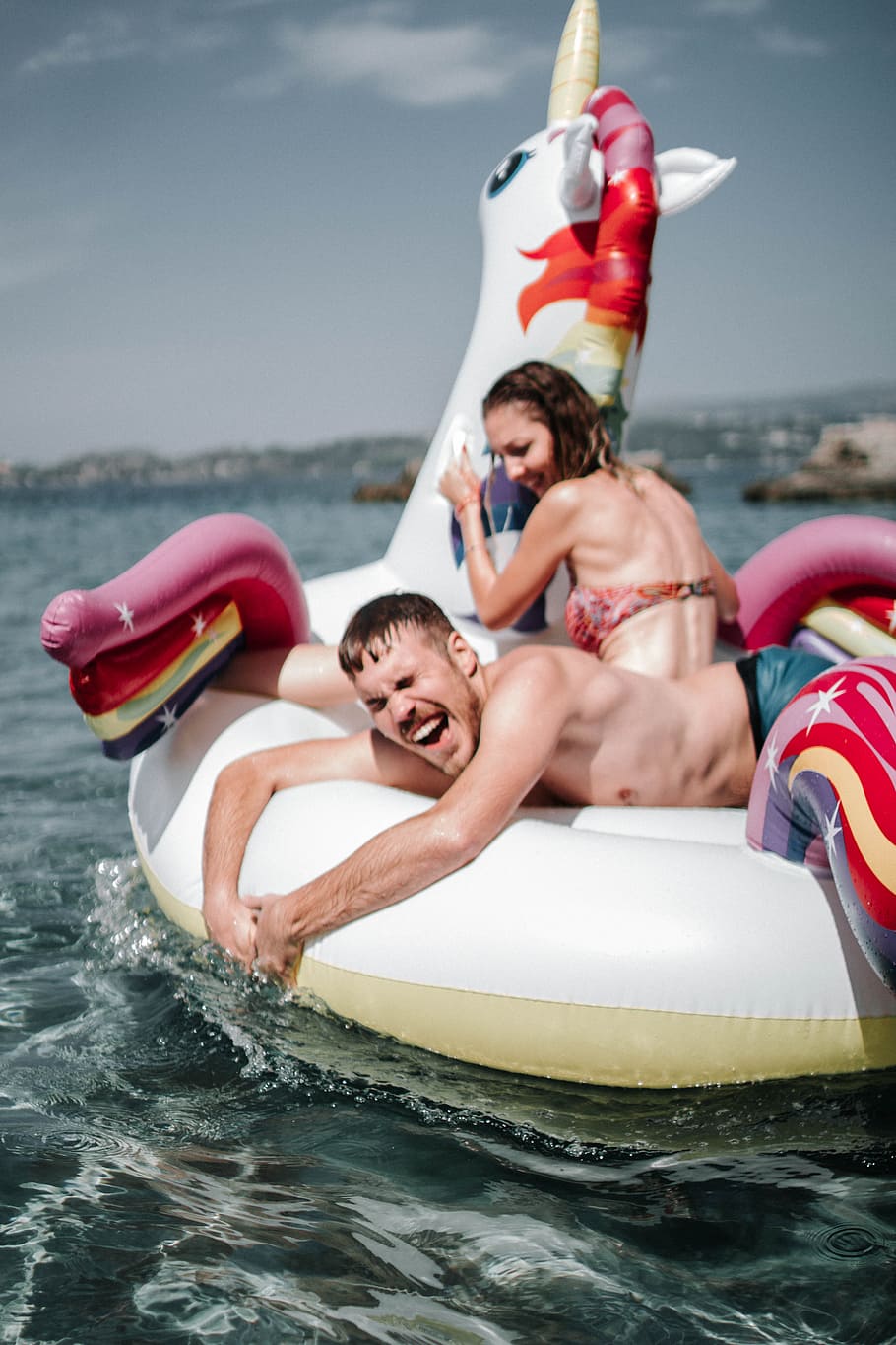 Couple Riding Unicorn Inflatable Floater, beach, enjoyment, fun HD wallpaper