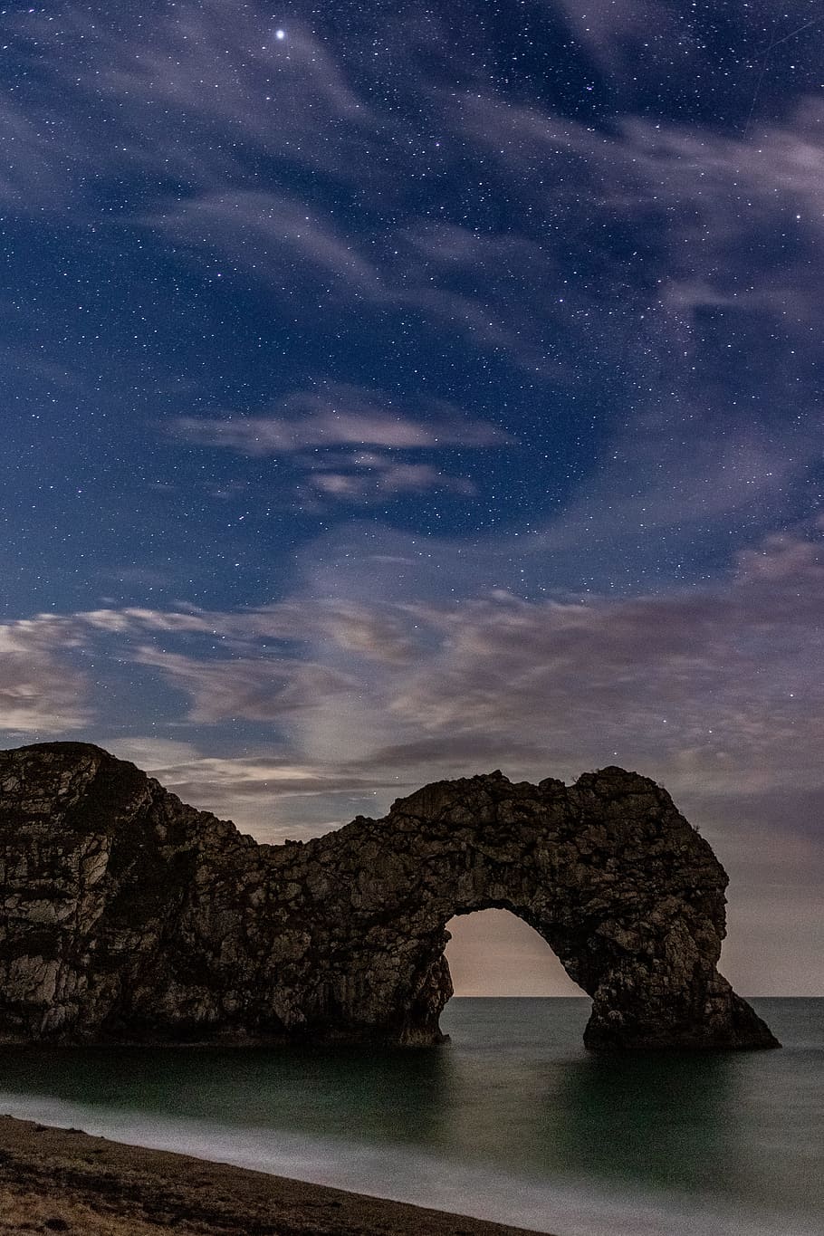 brown rock formation near shoreline at nighttime, ocean, sky HD wallpaper