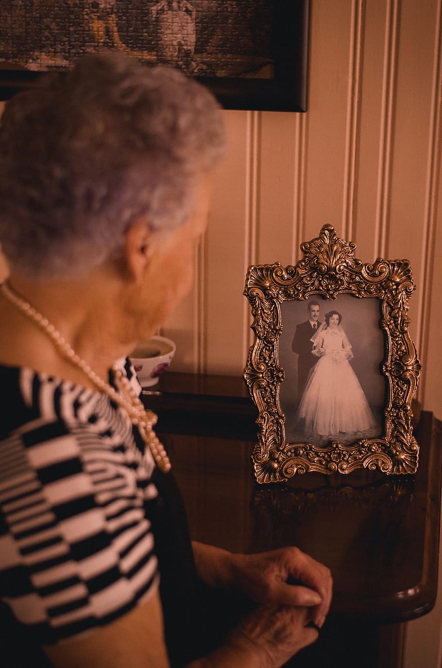 Woman Standing Near Photo Frame With Newly Wed Couple Picture