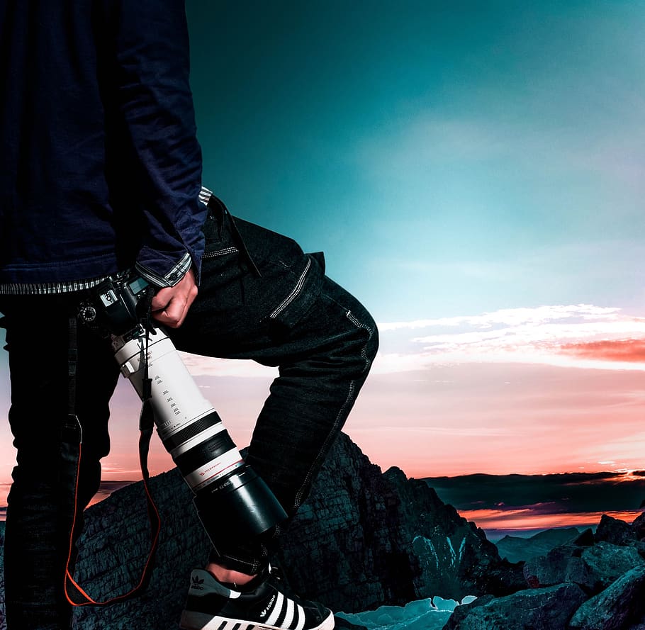 Man Wearing Black Bomber Jacket and Denim Jeans Holding Dslr Camera HD wallpaper