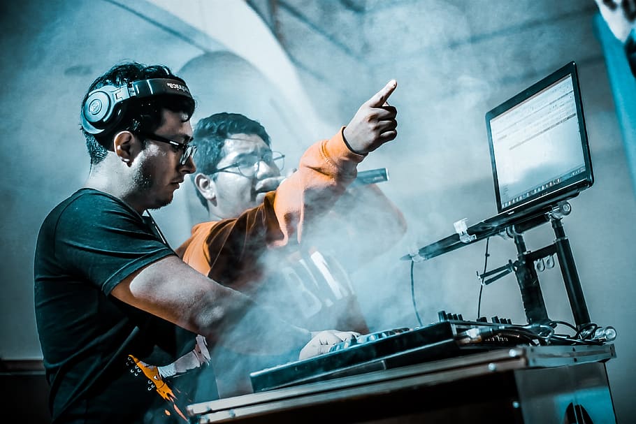 man controlling DJ controller beside man with microphone, computer HD wallpaper