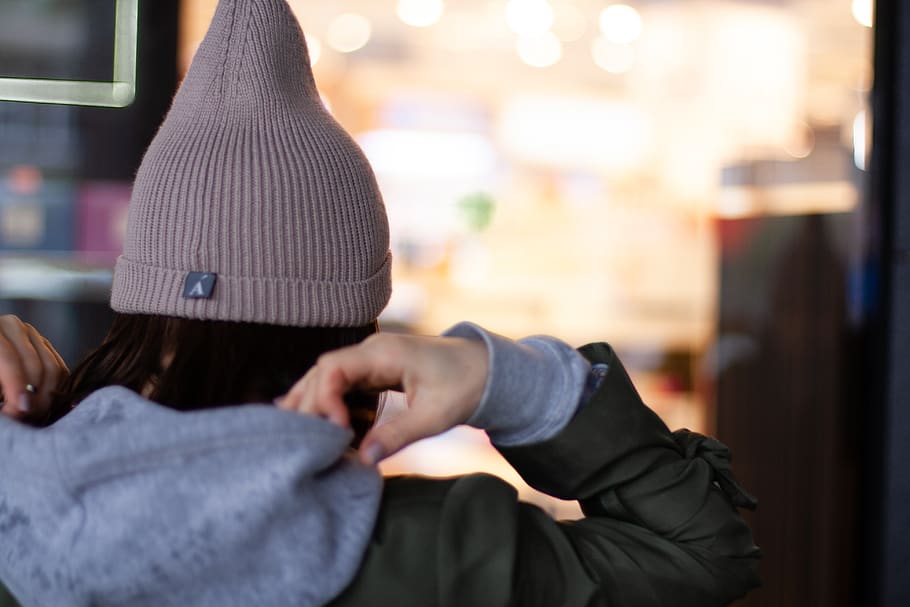 Woman Holding Her Gray Hoodie, beanie, fashion, girl, wear, focus on foreground