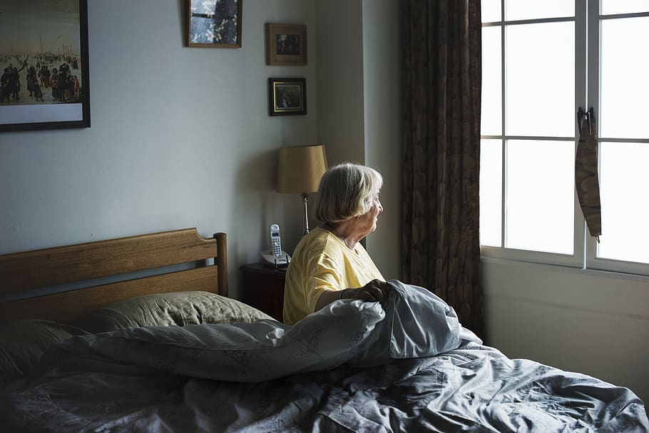 Woman Sitting On Bed Looking Out Window Inside Room, bedroom, HD wallpaper