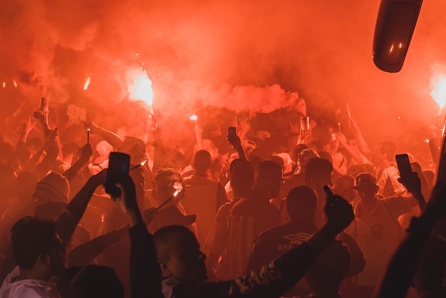 Crowd Holding Flares While Gathered on Open Area at Night Time HD wallpaper