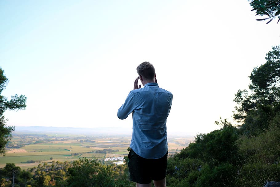 Man in Blue Dress Shirt Standing in Front of Landscape, back HD wallpaper
