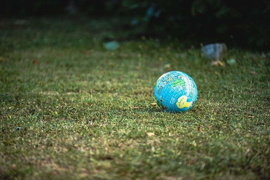 blue and white desk globe on green grass field during daytime HD wallpaper