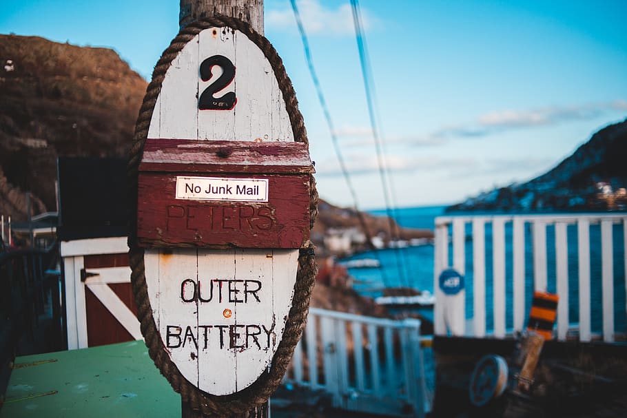 selective focus photo of outer battery signage on post, transportation