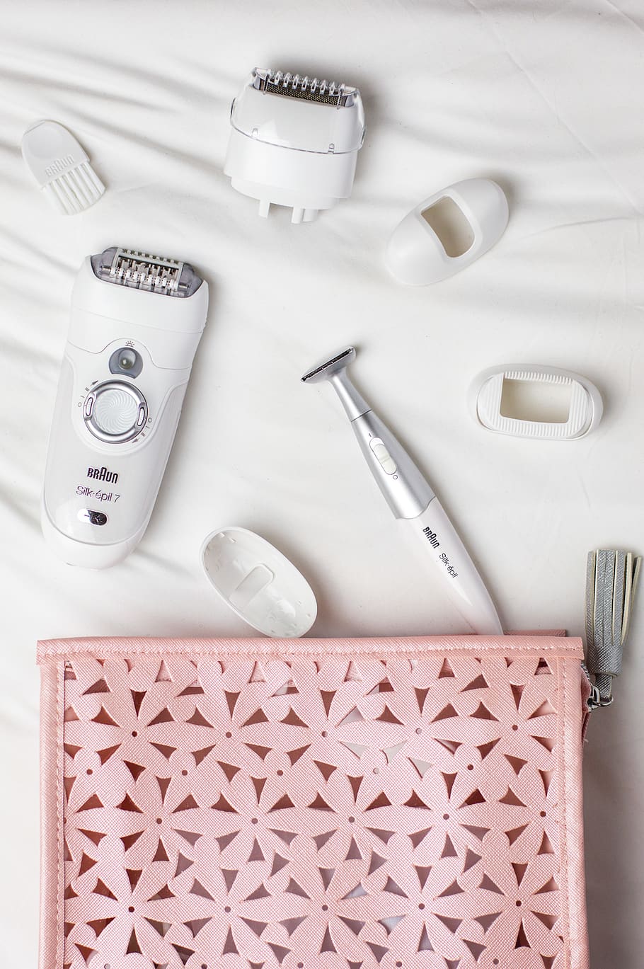 epilator and shaver on white cloth, indoors, still life, no people