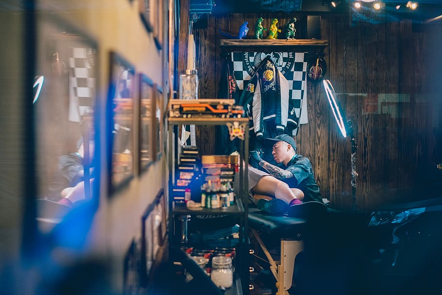man holding tattoo machine, indoors, working, men, occupation