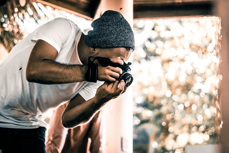 man holding camera during daytime, one person, focus on foreground HD wallpaper
