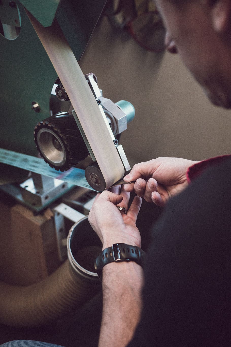 man fixing belt-driven machine, real people, human hand, indoors HD wallpaper