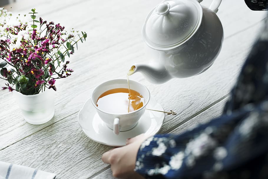 Person Holding White Ceramic Teapot and Pouring Tea in Cup, afternoon, HD wallpaper
