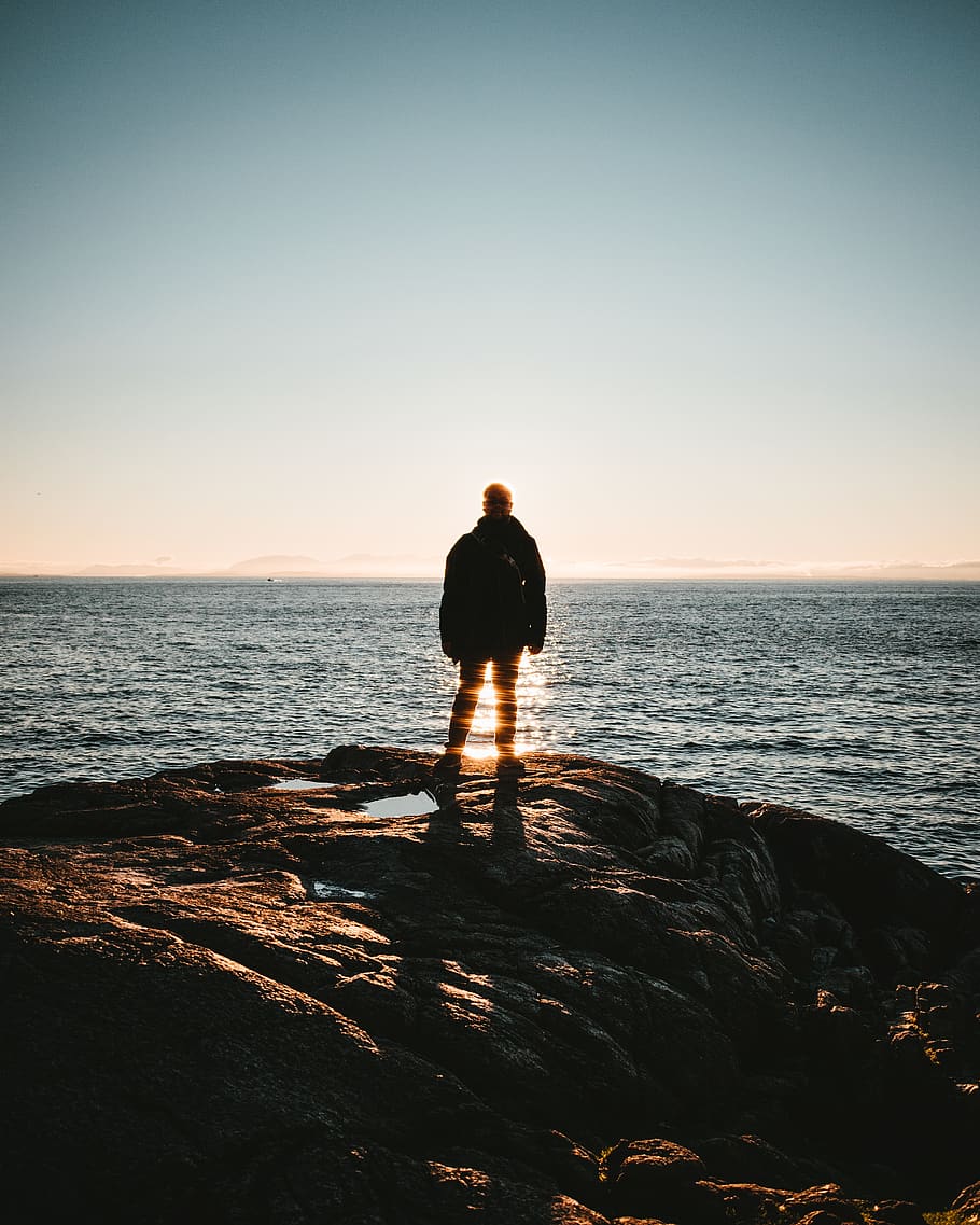 man standing on seacliff, water, sky, one person, real people HD wallpaper