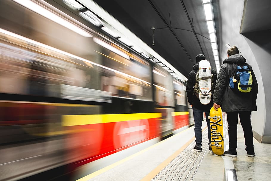 time-lapse photo of two men standing near train, subway, person HD wallpaper