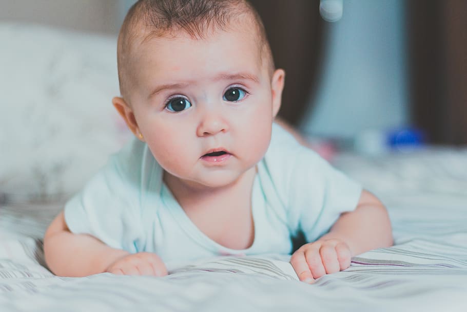 Baby in Whit Shirt Crawling on Bed, adorable, bedroom, blurred background
