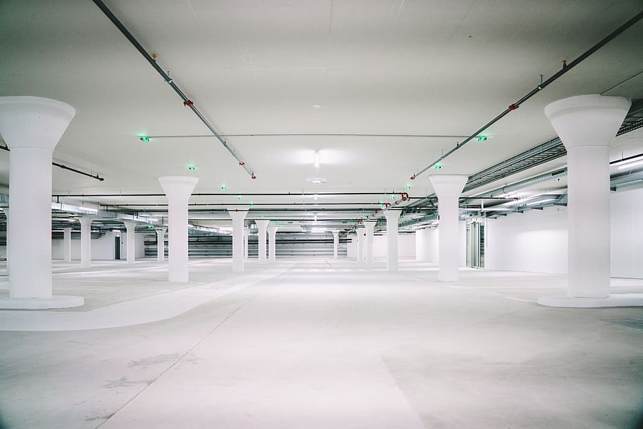 empty white concrete pillared parking lot, car, vehicle, automobile