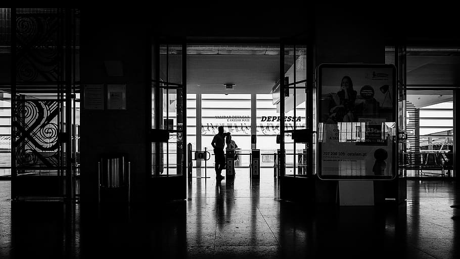 person standing on floor tiles grayscale photo, corridor, human