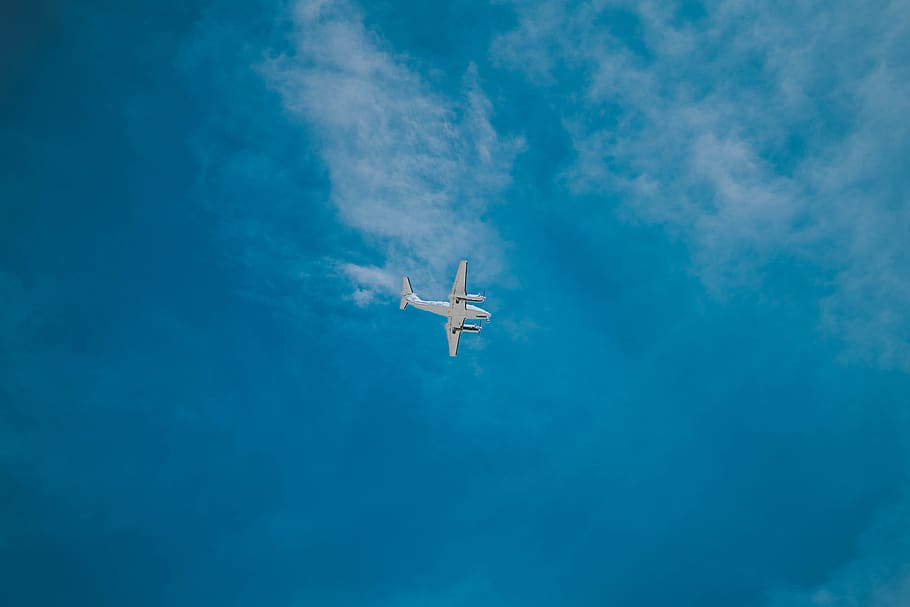 white airplane flying under cloudy sky, air vehicle, blue, low angle view HD wallpaper
