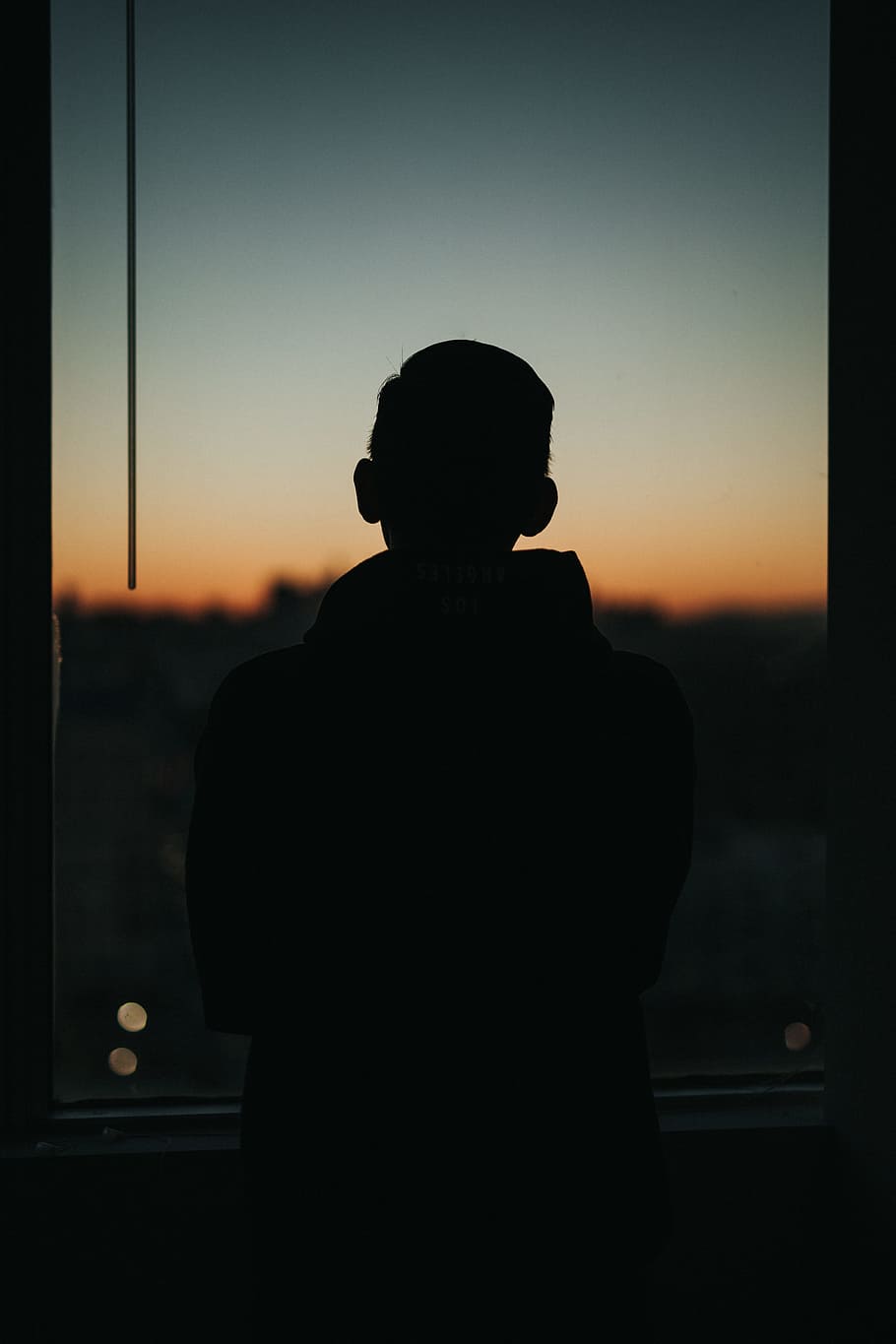man standing front of glass window, shadow, silhouette, outline