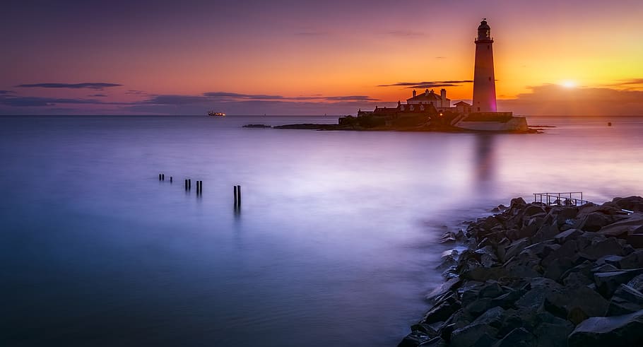 Lighthouse On Island Under Orange Sunset, architecture, dawn HD wallpaper