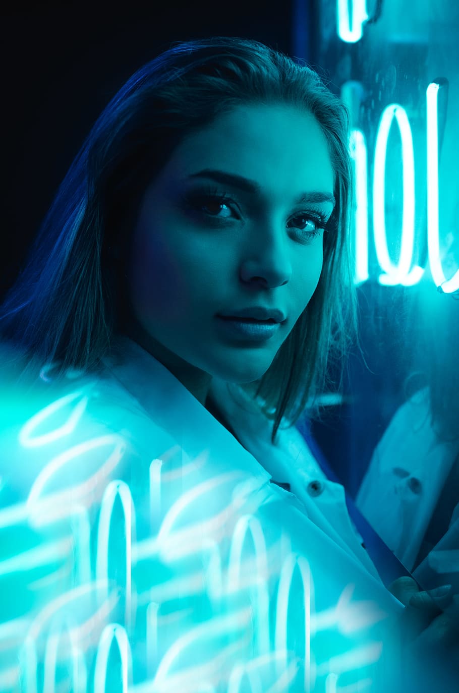 closeup photo of woman near neon light signage, portrait, blur
