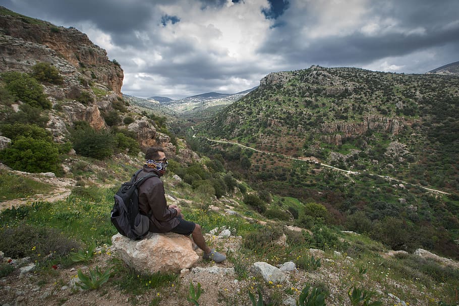 Man Sitting on Brown Boulder Top on Hill, adventure, clouds, environment HD wallpaper
