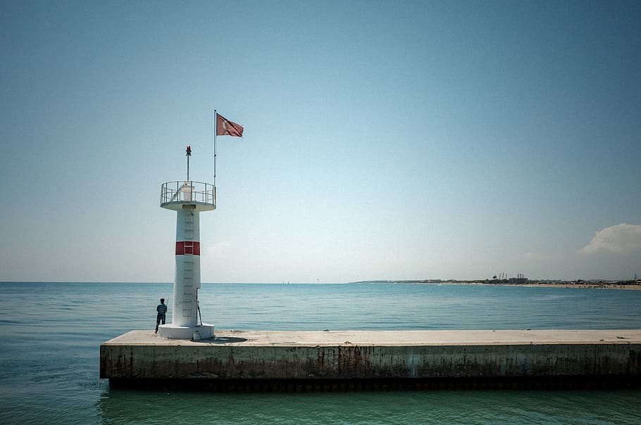 man standing beside tower on dock, person, human, building, architecture HD wallpaper