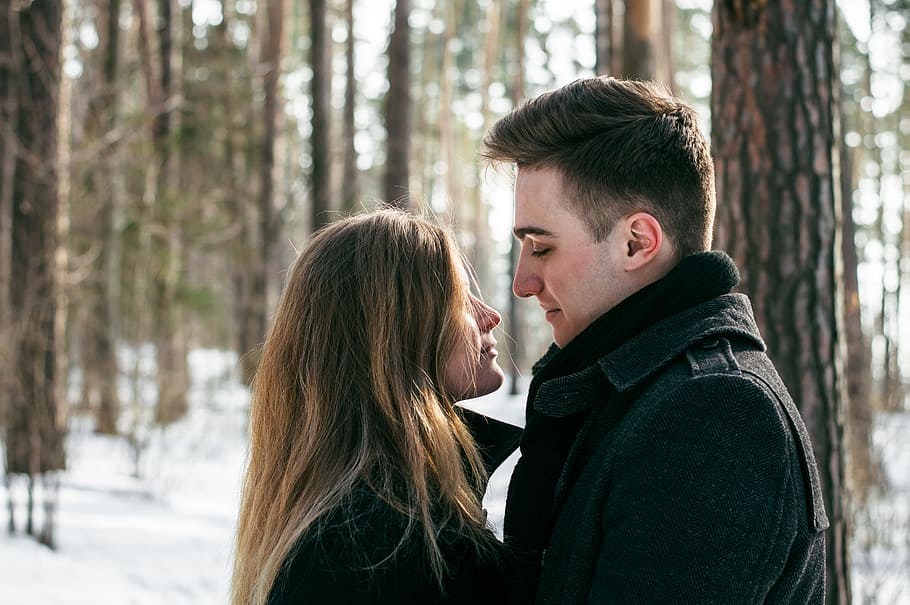 Man Wearing Black Coat Facing Woman Wearing Black Coat Near Tree HD wallpaper