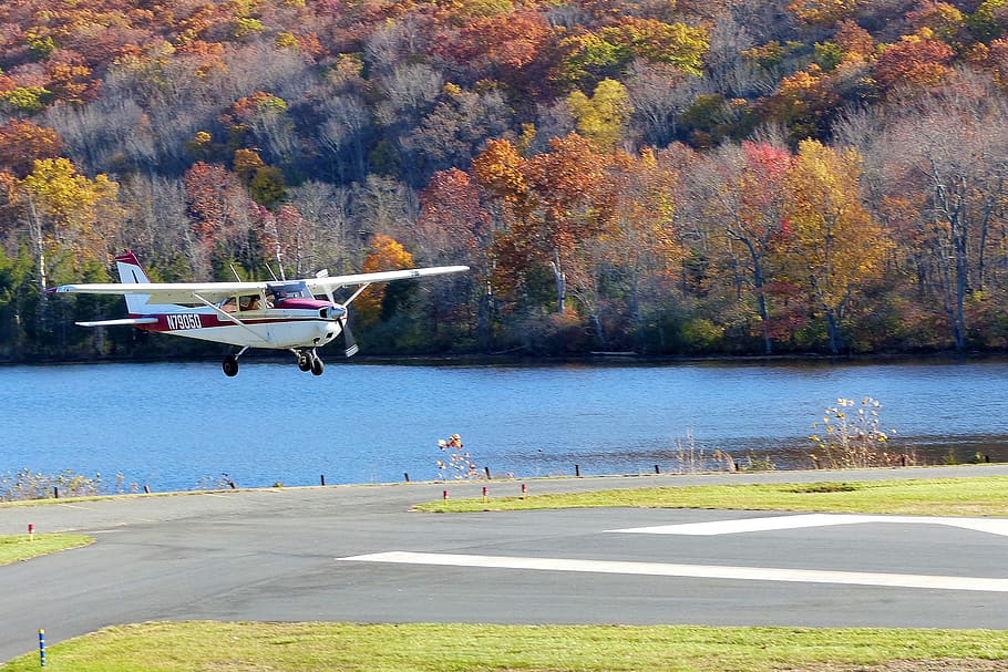 A Cessna single engine private airplane on the tarmac coming in for a landing.