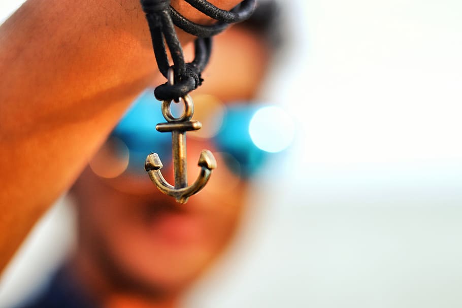 Selective Focus Photography of Anchor Pendant, action, art, blur HD wallpaper