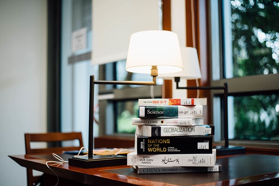 book stack beside table lamp, lighting equipment, electric lamp