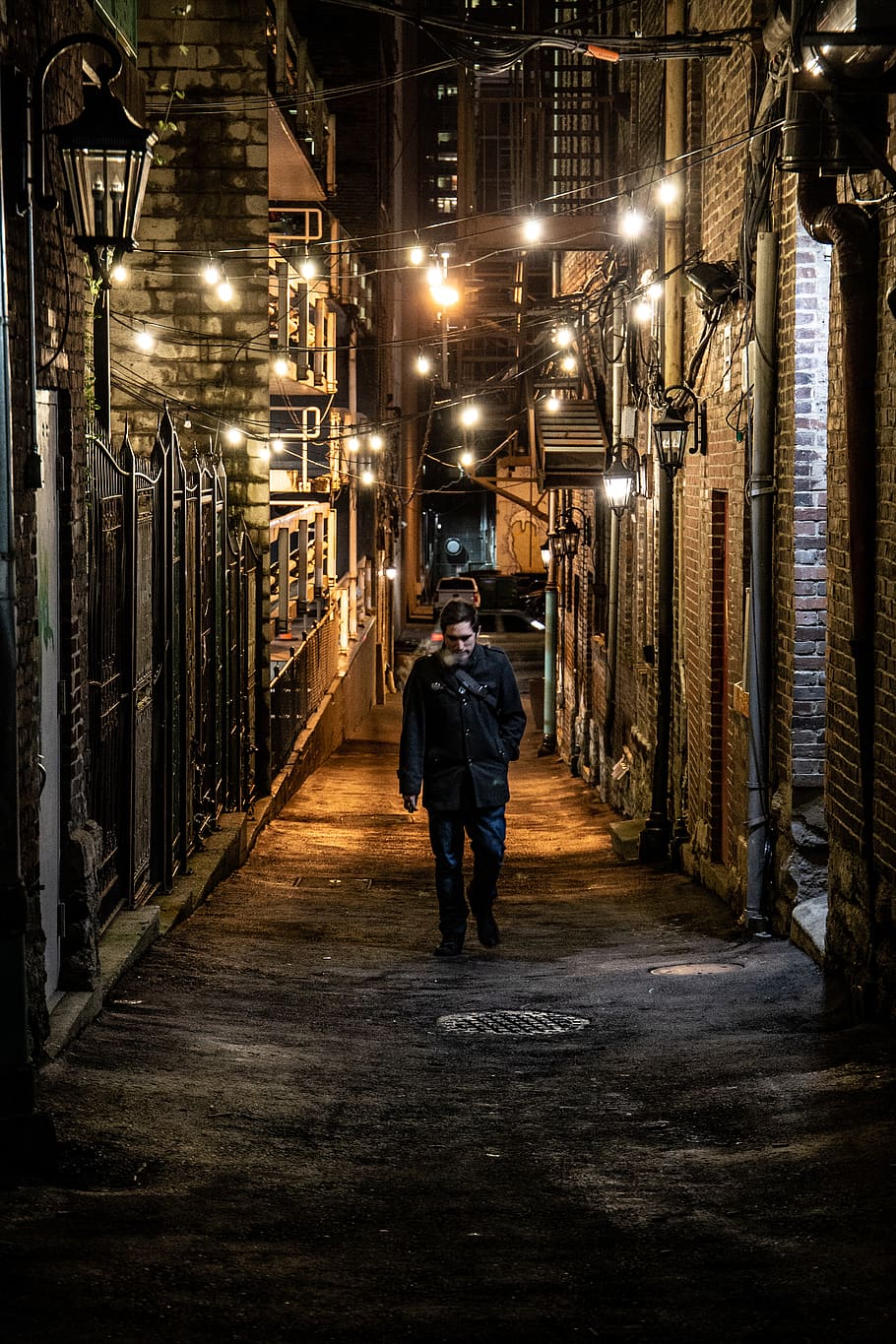 man walking between concrete building, illuminated, architecture HD wallpaper