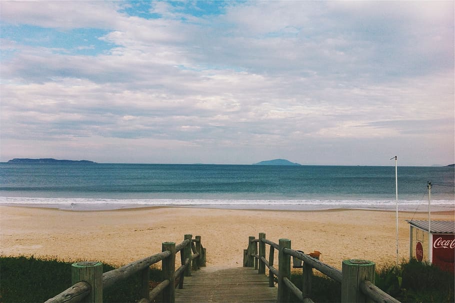 beach, sand, shore, waves, ocean, sea, wood, bridge, sky, clouds HD wallpaper