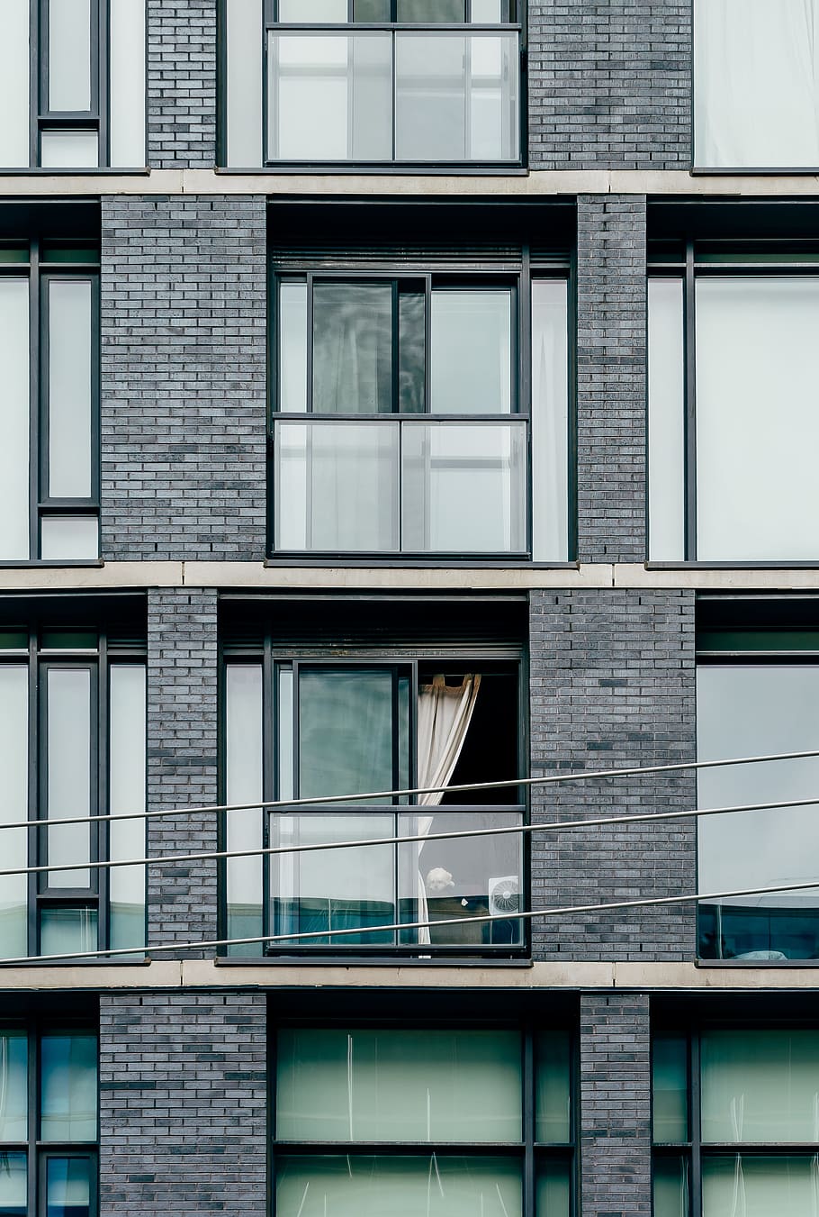 gray concrete building with glass windows, apartment, apartment exterior